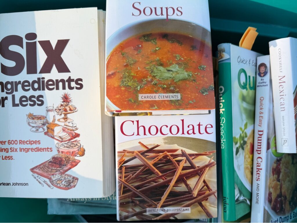 A tote with a variety of cook books.
